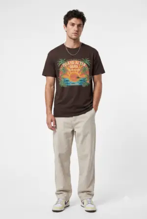 A vintage vacation club graphic with an after-dark attitude. Island After Dark blends tropical palms, sunset colors and ocean waves into an easygoing retro streetwear tee.