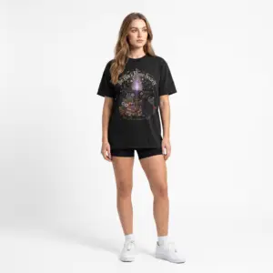 Comfort Colors 1717 black garment-dyed Halloween t-shirt featuring The Black Flame Society graphic with black cats, candles, purple flame, pumpkins, spell books, and witchy aesthetic artwork