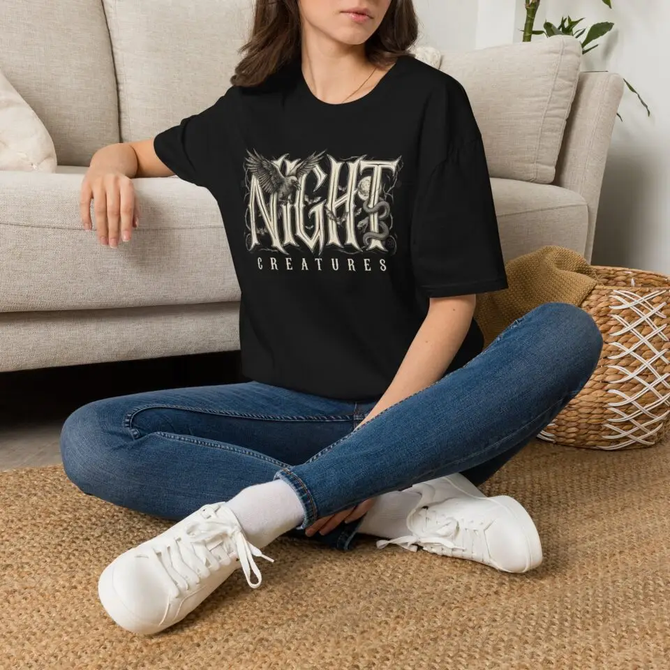 A dark gothic graphic tee featuring a raven and vintage-inspired lettering. Lightweight, unisex and made for Halloween season, late-night looks and everyday streetwear.