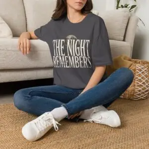 Front Mockup 1 The Night Remembers gothic moon graphic t-shirt featuring vintage typography, full moon, bats and haunted tree artwork. Front Mockup 2 Women's gothic Halloween graphic tee with The Night Remembers vintage moon design. Front Mockup 3 Vintage Halloween t-shirt with bold gothic typography and spooky moon artwork. Front Mockup 4 Dark aesthetic graphic t-shirt featuring The Night Remembers moon and haunted forest illustration. Back Mockup 1 Back view of The Night Remembers gothic Halloween t-shirt showing premium unisex fit. Back Mockup 2 Rear view of premium Gildan 64000 Halloween graphic tee from Brumbynorth. Close-up 1 Close-up of premium DTG printed gothic moon artwork on soft ring-spun cotton fabric. Close-up 2 Detailed close-up of The Night Remembers Halloween graphic showing crisp vintage typography and moon illustration.