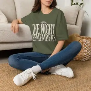 Front Mockup 1 The Night Remembers gothic moon graphic t-shirt featuring vintage typography, full moon, bats and haunted tree artwork. Front Mockup 2 Women's gothic Halloween graphic tee with The Night Remembers vintage moon design. Front Mockup 3 Vintage Halloween t-shirt with bold gothic typography and spooky moon artwork. Front Mockup 4 Dark aesthetic graphic t-shirt featuring The Night Remembers moon and haunted forest illustration. Back Mockup 1 Back view of The Night Remembers gothic Halloween t-shirt showing premium unisex fit. Back Mockup 2 Rear view of premium Gildan 64000 Halloween graphic tee from Brumbynorth. Close-up 1 Close-up of premium DTG printed gothic moon artwork on soft ring-spun cotton fabric. Close-up 2 Detailed close-up of The Night Remembers Halloween graphic showing crisp vintage typography and moon illustration.