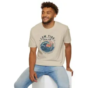 A laid-back surf tee built around a vintage coastal crest, curling wave, pastel sunset, and retro Low Tide Social Club lettering. Easy everyday streetwear with a relaxed summer feel.