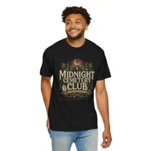 Front View Woman wearing a Comfort Colors Midnight Cemetery Club Halloween graphic t-shirt featuring vintage gothic typography, moonlit cemetery artwork, and a relaxed garment-dyed fit. Lifestyle Alt Text Premium Comfort Colors 1717 garment-dyed Halloween t-shirt with Midnight Cemetery Club vintage cemetery design, photographed on a female model in a casual lifestyle setting.