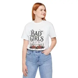 Front Mockup 1 Woman wearing the Bad Girls Go to the Haunted House Halloween graphic t-shirt featuring vintage typography, pumpkins, bats, and spiderweb artwork. Front Mockup 2 Cute Halloween graphic tee with "Bad Girls Go to the Haunted House" design on a premium Bella+Canvas 3001 t-shirt. Front Mockup 3 Women's spooky season t-shirt featuring vintage pumpkin artwork and playful Halloween typography. Front Mockup 4 Bella+Canvas Halloween t-shirt with gothic lettering, smiling jack-o'-lanterns, bats, and autumn floral details. Back Mockup 1 Back view of the Bella+Canvas 3001 Halloween graphic t-shirt showing the modern retail fit. Back Mockup 2 Rear view of the premium unisex Halloween t-shirt from Brumbynorth. Close-up 1 Close-up of the premium Halloween graphic print showing detailed typography, pumpkins, and bats. Close-up 2 Detailed close-up of the DTF printed Halloween artwork on soft Airlume combed ring-spun cotton