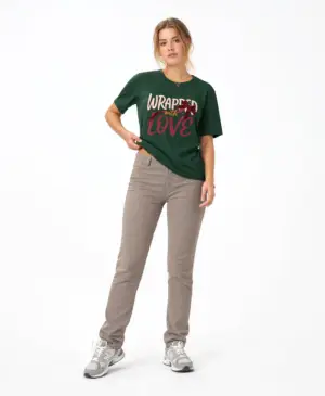 Woman wearing a black Wrapped with Love Christmas graphic t-shirt featuring festive typography with a holiday ribbon and gift bow design.