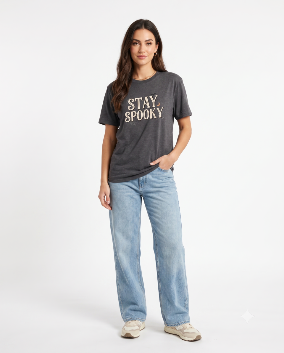 A black Stay Spooky Halloween t-shirt featuring a retro script chest graphic with subtle Halloween accents.