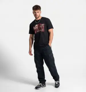 Model wearing a black Spooky Night Creatures gothic raven graphic unisex T-shirt Short Product Text A dark Halloween-inspired graphic tee featuring gothic lettering, a raven, and a vintage-horror feel. Made from lightweight ring-spun cotton for an easy everyday streetwear fit.