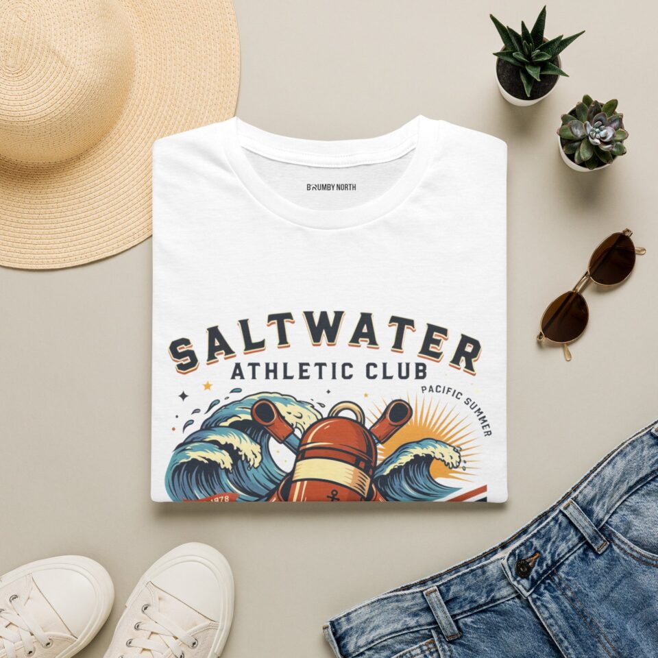 Saltwater Athletic Club T-shirt design featuring vintage ocean waves, a nautical buoy, crossed paddles, rising sun, and retro coastal typography.