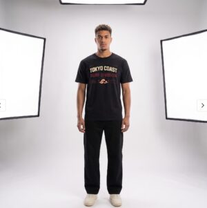 Tokyo Coast Surf Division Japanese wave graphic T-shirt shown from the back on a male model in a studio. Short SEO Alt Text Tokyo Coast Japanese wave graphic back print T-shirt